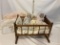 Wooden Cradle with Three Dolls