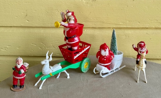Four Plastic Santa Claus Figures