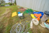 Tarps, Cable, Hoses and Bed Mats Outside Building