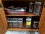 cabinet of glass storage containers, bake pans and misc utensils