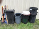 assorted trash cans and brooms