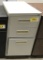 metal file cabinet with 1 letter file drawer and 2 utility drawers; beige;