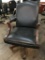 rolling arm chair; black leather with wood