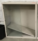 metal shelving unit with sliding doors; beige; measures 36