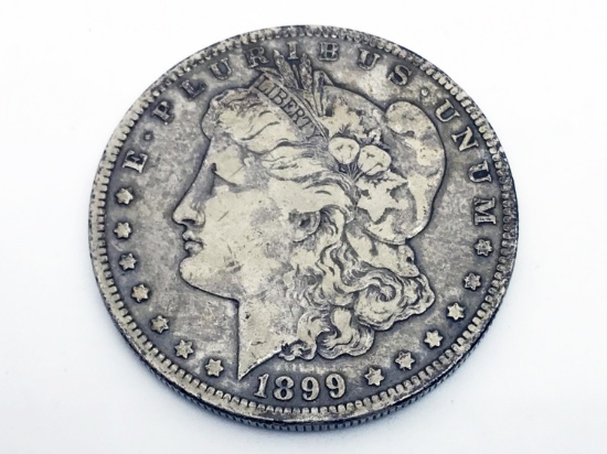 1899-O Morgan silver dollar. Due to increased fraud activity, any coin/jewelry purchase totaling ove