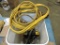 Bucket of assorted jumper cables, cords, lights