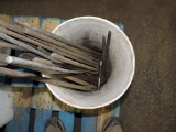 Bucket of blacksmith forge tongs