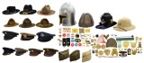 LARGE ASSORTMENT OF MILITARY HATS, INSIGNIA &