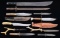 6 KNIVES, A BAYONET, A MACHETE, & A CARVING SET.