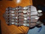 Silver spoons with wall display