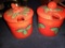 Two red and green ceramic jam jelly jars