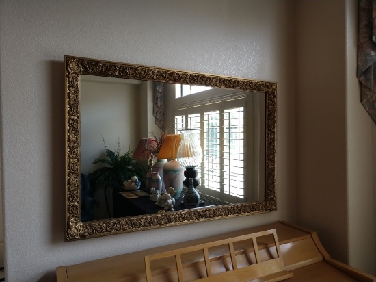 Gold-tone, ornately framed wall mirror 54x35