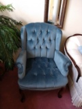 Tufted upholstered blue armchair
