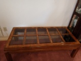 Wood coffee table with glass paned top