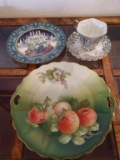 2 decorative plates and a teacup with saucer