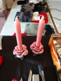 Two pink floral candle sticks with candles