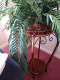 Large plastic fern in tall basket plant holder