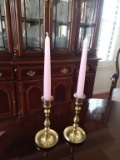 Two brass candle sticks with pink candles