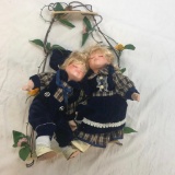 2 Porcelain Girl and Boy Dolls on Hanging Bench