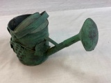Small green metal watering can with grape design on the side