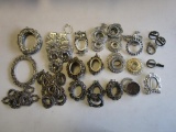 Large lot of gold-tone and silver-tone metal jewelry settings for pendants, frames, money clips and