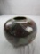 Ceramic brown, sage green, and maroon-colored vase