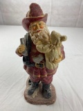 Glitter plastic Santa Fireman figure holding a child