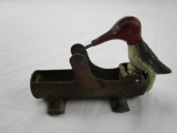 Vintage cast iron and brass woodpecker toy