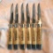 Lot of 6 Identical Vintage Stainless Steel Steak Knives with White Handles and Gold-Toned Detail