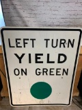 Left Turn Yield On Green Metal Road Sign
