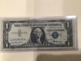 1957 $1.00 Blue Seal U.S. Bill in circulated condition serial number L30128330A