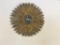 Gold tone starburst pattern plastic wall clock. Works.