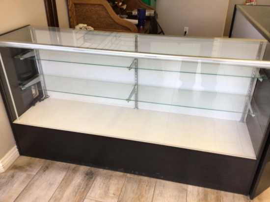 nice display case with 2 glass selves, has glass top, 70 inches long, 18 inches deep and 38 inches