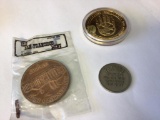 Lot of three commemorative coins, one in plastic, one in airtime