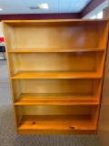 Solid light-wood bookcase with 4 built in shelves