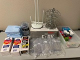 Large lot of kitchen items: plastic silverware, napkins, coffee pod and paper towel holders, & more