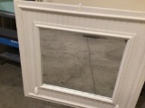 37? by 34? Framed Mirror painted white with two hocks on the bottom of the frame.