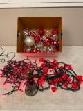 Box lot of red and white holiday items: lights, angel tree topper, and ornaments
