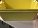 Lot of five hard plastic bins, two large yellow, 2 small red and one small green. No lids