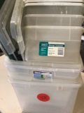 seven various size clear totes with lids.