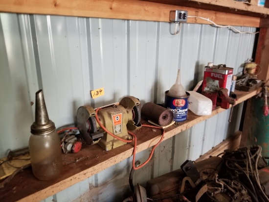 Contents of bottom shelf, grinder, sander, tank