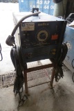 Miller Dialarc 250 AC/DC Welding Power Source with Leads on Heavy Duty Steel Stand.