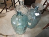 (3) 5-Gallon Glass Water Jugs.