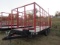 Stoltzfus Manufacturing Tri-Axle Flatbed Trailer with Hay Rack