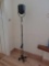 Patinated Metal Tilting Head Roll Around Standing Lamp