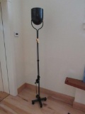 Patinated Metal Tilting Head Roll Around Standing Lamp