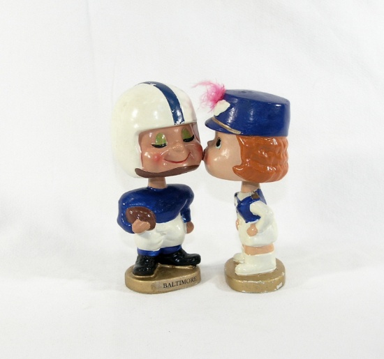 1960s Baltimore Colts "My Hero" Boy and Girl Kissing Bobbleheads Set. Gold