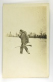 145.  1920’s RPPC Berg Photo of Uncle Pete Myer Carrying a Wolf he had just