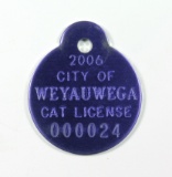147. 2006 Stamped Purple Aluminum:  CITY OF WEYAUWEGA CAT LICENSE 000024.