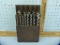 13 Winchester drill bits in wooden stand, 10-5/8